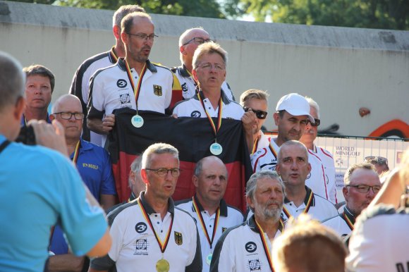 Siegreiche deutsche Seniorenteams mit Mainzer Beteiligung: Bei den Männern schwingt Roman Kobisch (Mitte) während der Siiegerehrung die deutsche Fahne.