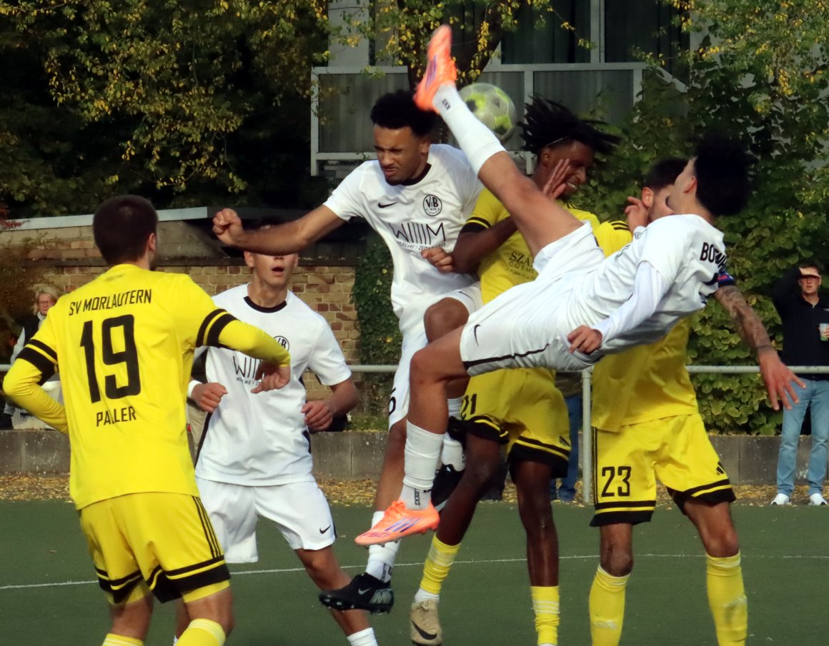Gruppenbild mit Fallrückzieher: Aliu Candé legt sich quer, während Elias Heine und der Morlauterner Wilson da Conceicao dahinter ein Kopfballduell ansetzen.